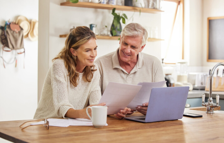 A couple with budget on laptop plan future home remodel