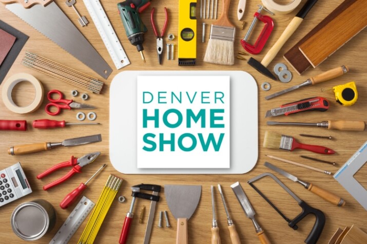 A table full of tools encircles a sign that reads "The Denver Home Show." By remodeling contractors Christie's Design/Build.